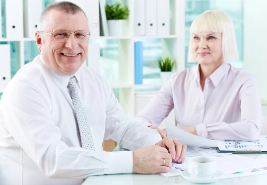 Co-workers are giving pose to a photographer