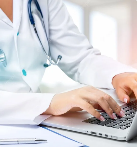 A physician working on a laptop